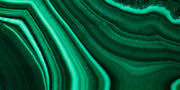 Wide close-up of green malachite with sweeping light and dark bands, a material reference for the Anohni necklace