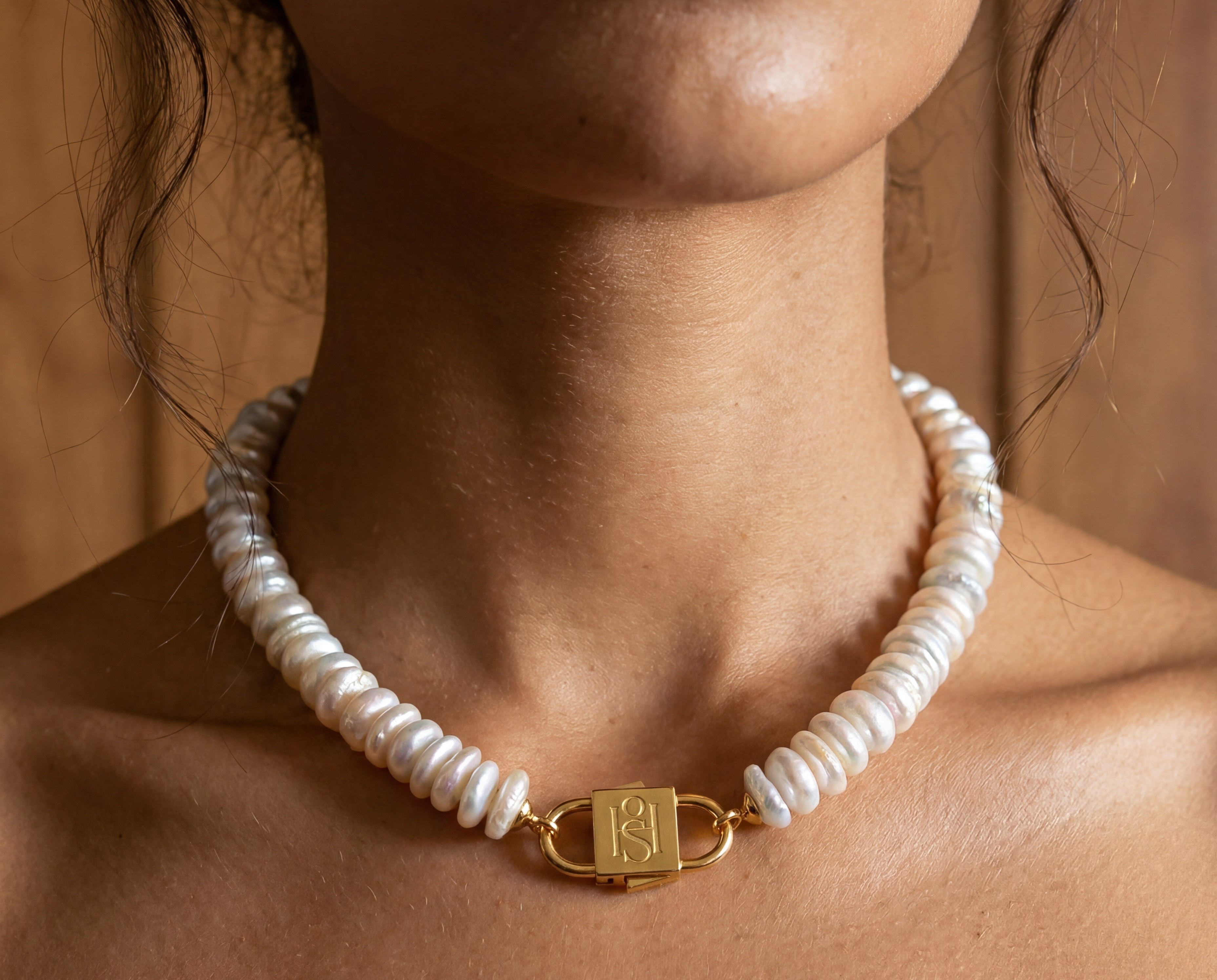 Fahrelnissa stacked coin pearl necklace styled on model with long dark hair, featuring House of Sól signature clasp.