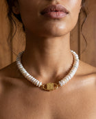 Fahrelnissa stacked coin pearl necklace styled on model with long dark hair, featuring House of Sól signature clasp.