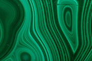 Close-up of green malachite with wavy bands and oval eye patterns, a material reference for the Anohni necklace