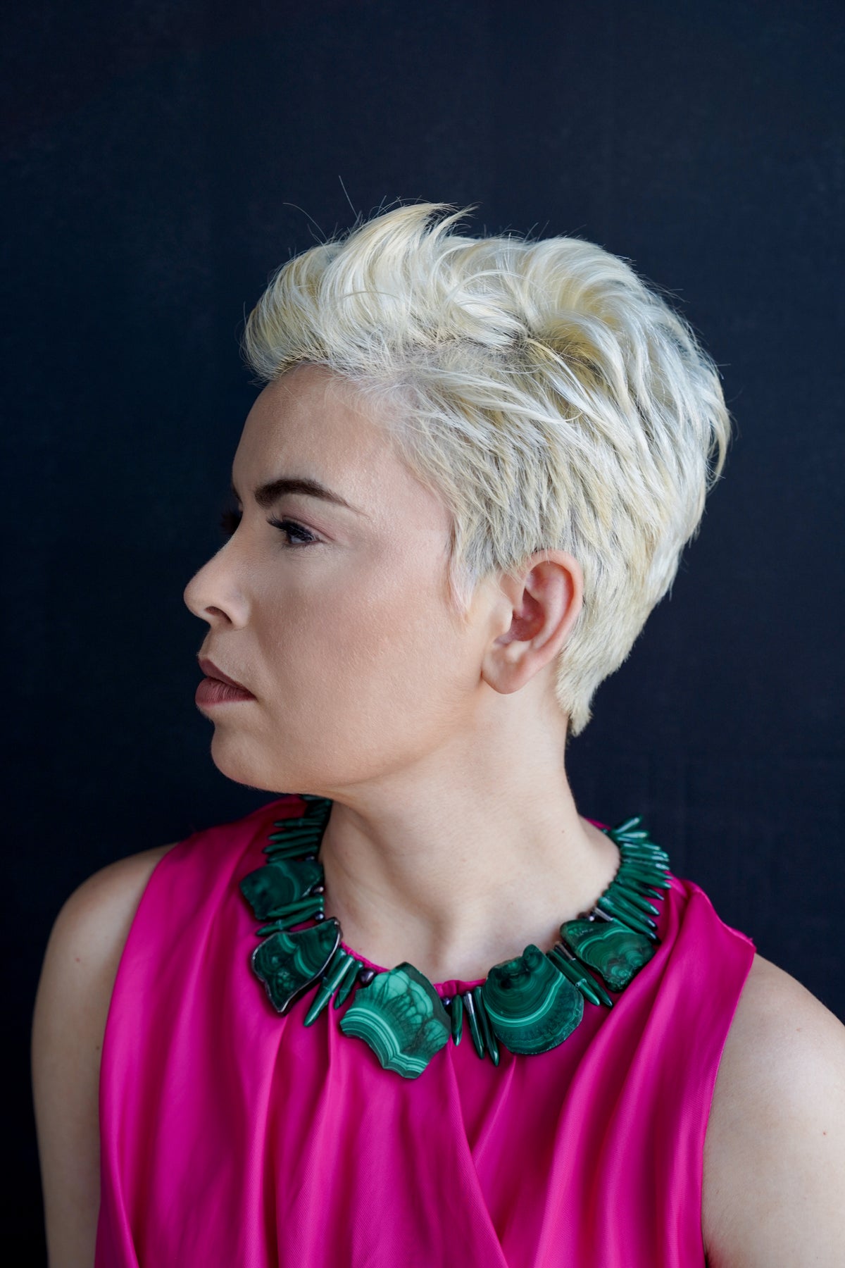 Anohni malachite necklace on model in profile against a dark backdrop