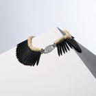 Black Nefertiti white coral and black howlite spike necklaces joined by the HoS Lock on a white block