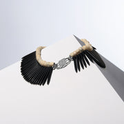 Black Nefertiti white coral and black howlite spike necklaces joined by the HoS Lock on a white block
