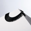 Black Only black howlite spike bead necklace draped over a white block