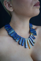 Doris lapis lazuli necklace worn at the neck and collarbone, close-up