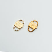 Two gold-tone HoS Locks with different finishes side by side on a white surface