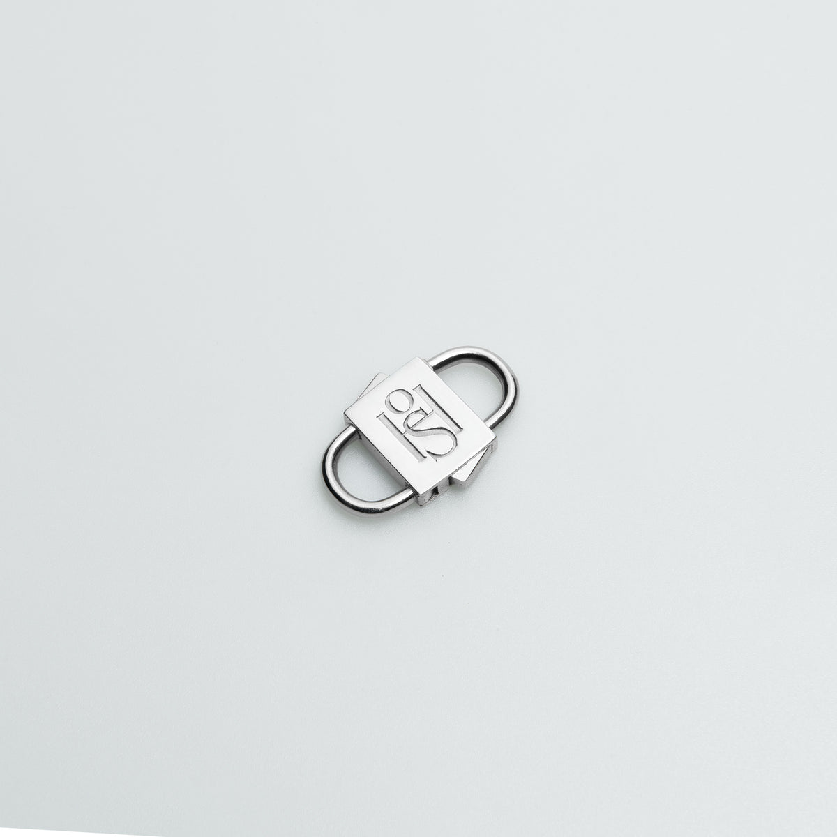 HoS Lock in white gold finish on sterling silver, shown closed on a white backdrop