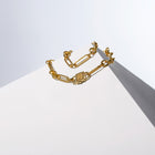 Medium Trombone Chain Necklace with HoS Lock arranged in two rows over a white block