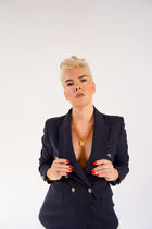 Medium Trombone Chain Necklace with HoS Padlock on a model in a navy double-breasted blazer