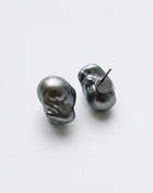 Perle Noire peacock baroque pearl earrings, one turned to show its monogrammed black rhodium plated back