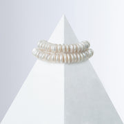Shirin rondelle pearl bracelet styled as a double line on a white pyramid, back view