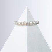Shirin single-strand rondelle pearl bracelet on a white pyramid, back view with the HoS Lock hidden
