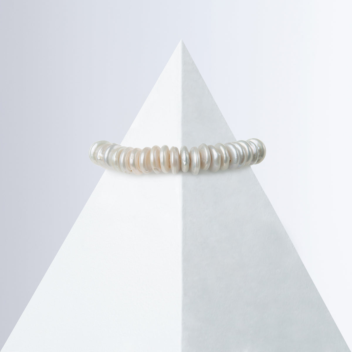 Shirin single-strand rondelle pearl bracelet on a white pyramid, back view with the HoS Lock hidden