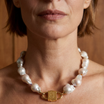 Ostrea baroque pearl necklace with House of Sól signature gold lock clasp, worn by brunette model with short bob cut