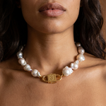 Ostrea baroque pearl statement necklace styled on model with long dark wavy hair, featuring House of Sól gold lock clasp.
