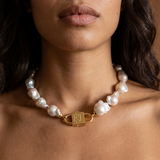 Ostrea baroque pearl statement necklace styled on model with long dark wavy hair, featuring House of Sól gold lock clasp.