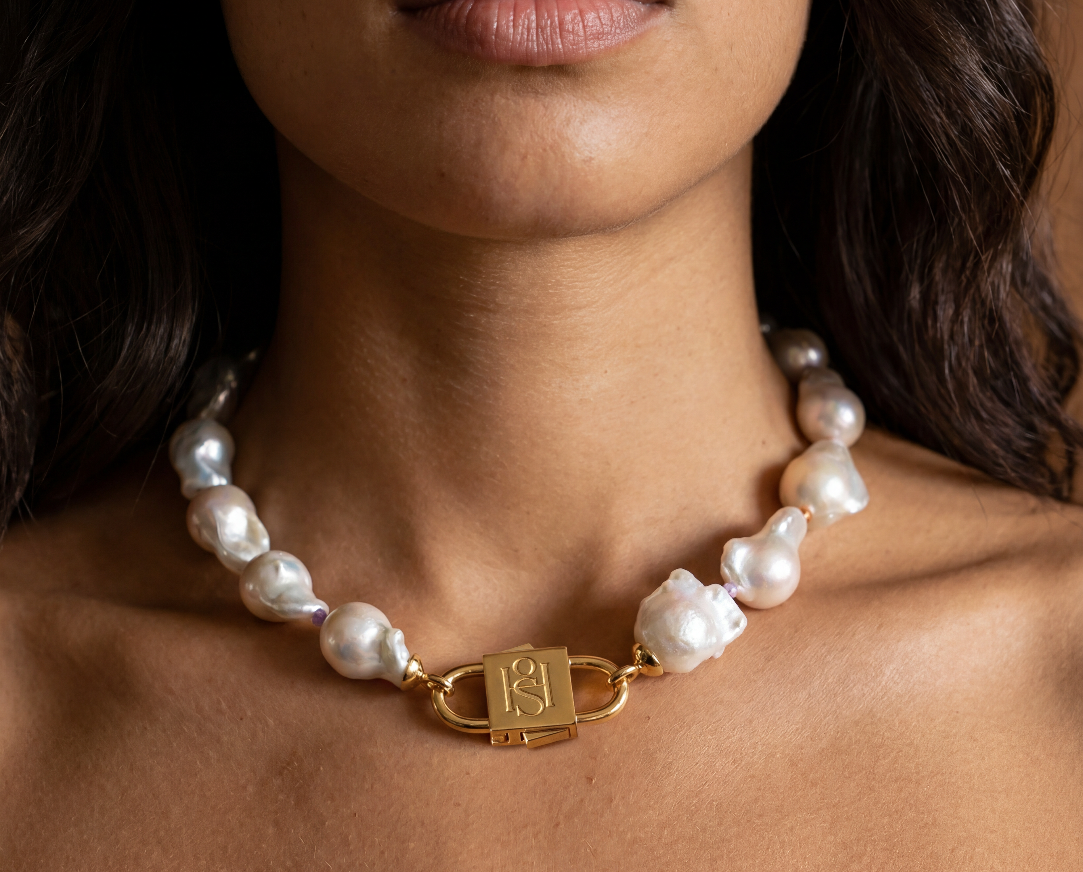 Ostrea baroque pearl statement necklace styled on model with long dark wavy hair, featuring House of Sól gold lock clasp.