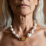 Ostrea baroque pearl necklace with engraved gold lock clasp by House of Sól, worn by silver-haired model.