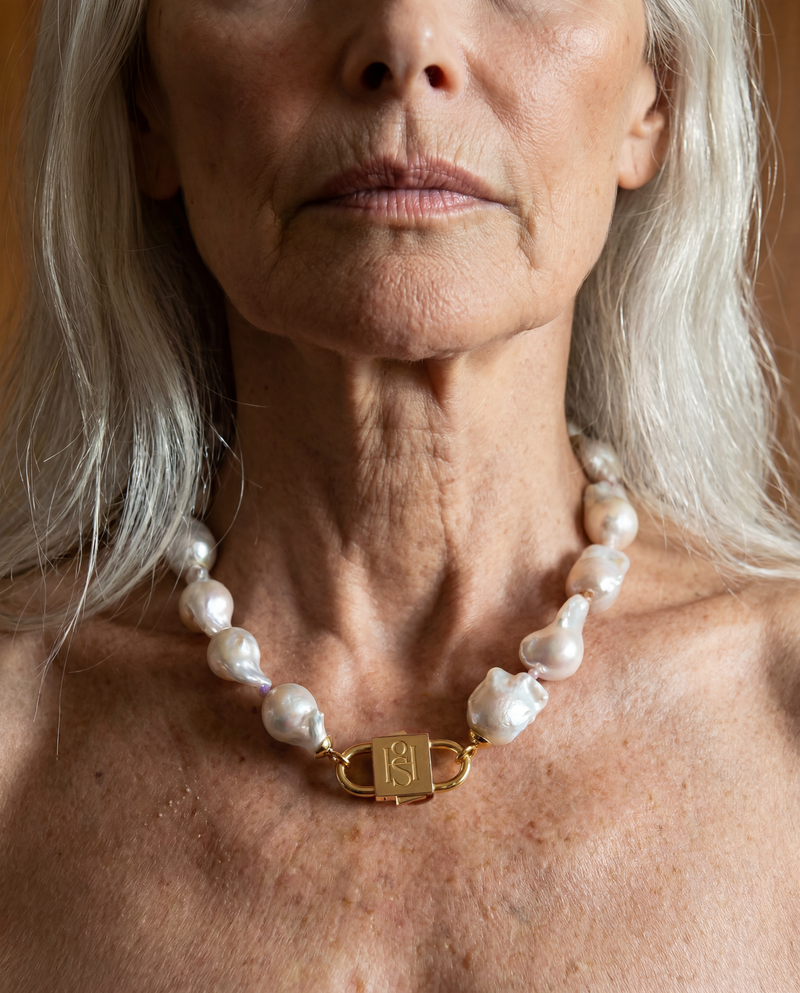 Ostrea baroque pearl necklace with engraved gold lock clasp by House of Sól, worn by silver-haired model.