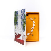 2021 Collector's Edition Box opened like a book, yellow velvet interior holding a necklace
