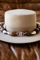 Light Walden necklace wrapped around a hat, joined by HoS Lock to a separate darker wood strand