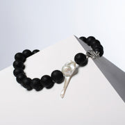 Luna necklace turned to show the baroque pearl and lava stones, HoS Lock seen side-on