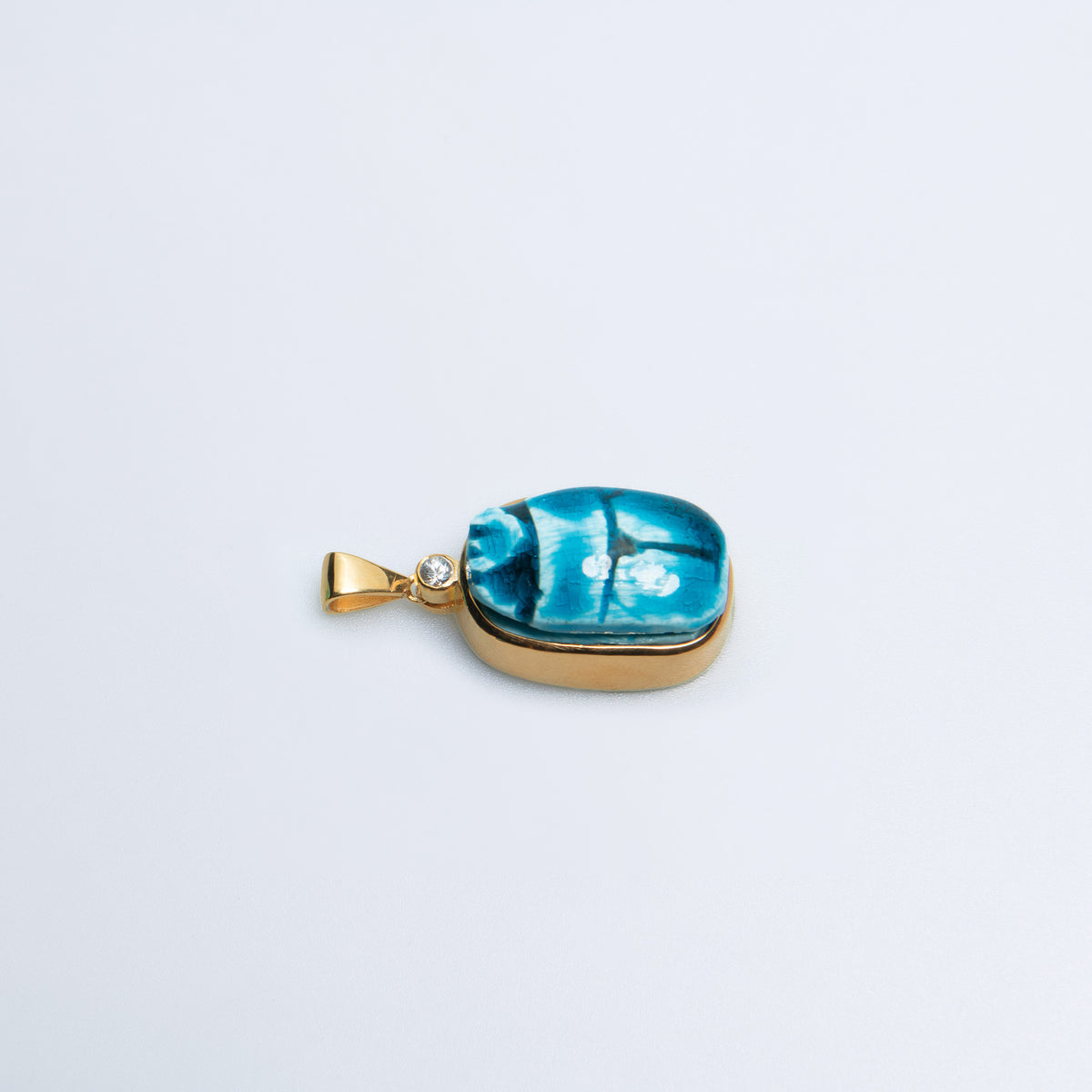 Scarab charm of blue Egyptian faience set in gold-filled sterling silver, seen from above